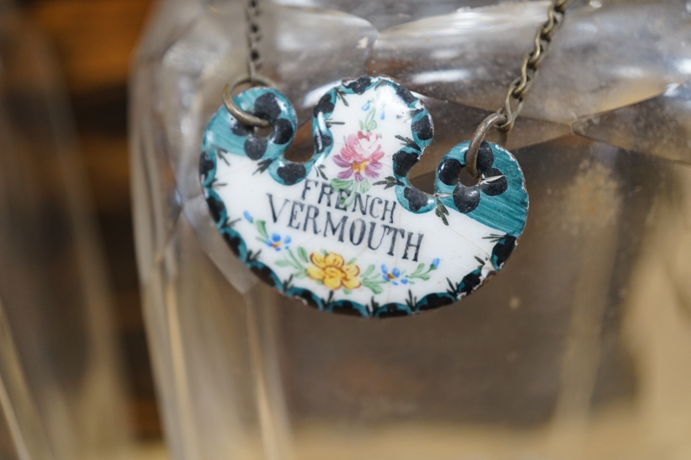 A Victorian coromandel four bottle decanter box with Bramah lock, three silver ‘hunting’ spirit labels and another enamelled, height of box 30cm